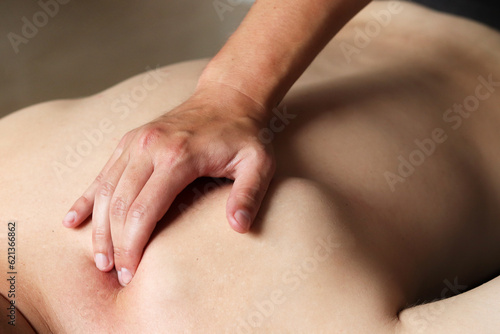 Masseur does back massage in spa center. Massage of myofascial trigger points on hands of male client to release tension. Rehabilitation  sport therapy medicine. Close-up.