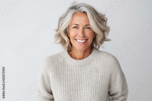 Portrait of a happy mature woman smiling at camera over white background
