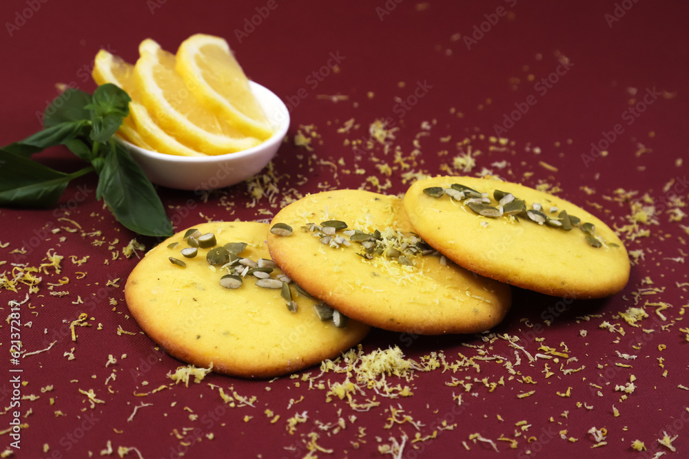 Fragrant yellow lemon cookies with pumpkin seeds on a burgundy table. Shallow depth of field Fragrant yellow lemon cookies with pumpkin seeds on a burgundy table. Shallow depth of field