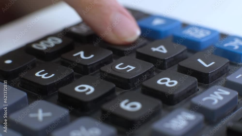 Finger presses the button calculator. close up and shallow depth of field. Counting money.Solving a mathematical problem. making such a calculation. calculating machine. Finger presses the button calculator. close up and shallow depth of field. Counting money.Solving a mathematical problem. making such a calculation. calculating machine.
