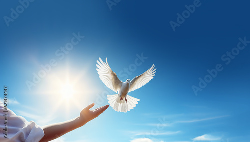 Hands releasing white doves in blue sky with sunrise during sunset. Symbol of Freedom and peace on blue background with copy space