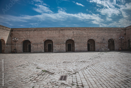 Оld historical vaulted hall in the interior of Castell de Montjuïc, Barcelona, Spain. View of the primitive Romanesque vault. Old military fortress