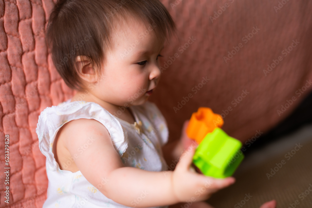lifestyle home portrait of adorable and beautiful Asian Caucasian mixed baby girl playing on the floor with color blocks excited and happy in childhood concept lifestyle home portrait of adorable and beautiful Asian Caucasian mixed baby girl playing on the floor with color blocks excited and happy in childhood concept