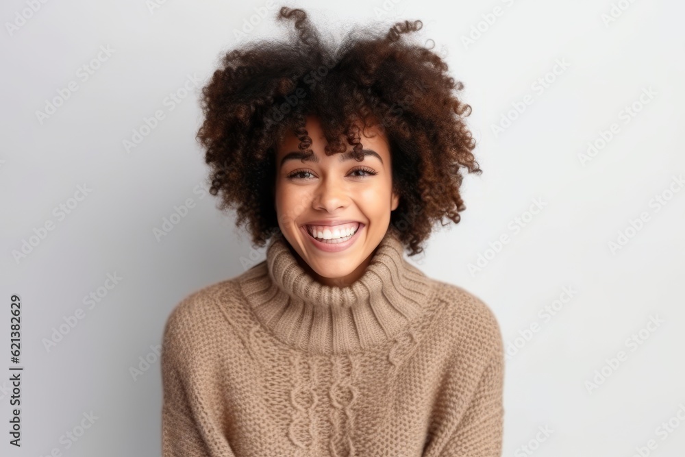 Portrait of a beautiful young african american woman with curly hair smiling at the camera Portrait of a beautiful young african american woman with curly hair smiling at the camera