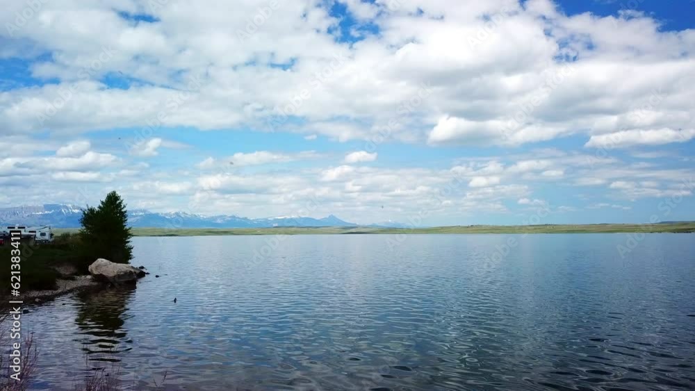 Aerial: Drone Flying Over Lake Near Mountain Ranges Against Cloudy Sky - Billings, Montana Aerial: Drone Flying Over Lake Near Mountain Ranges Against Cloudy Sky - Billings, Montana