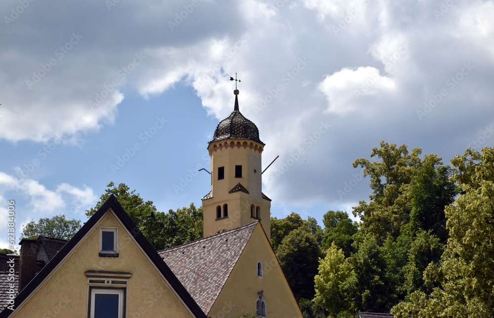 Turm der Michaelskirche in Heidenheim hinter Hausdächern
