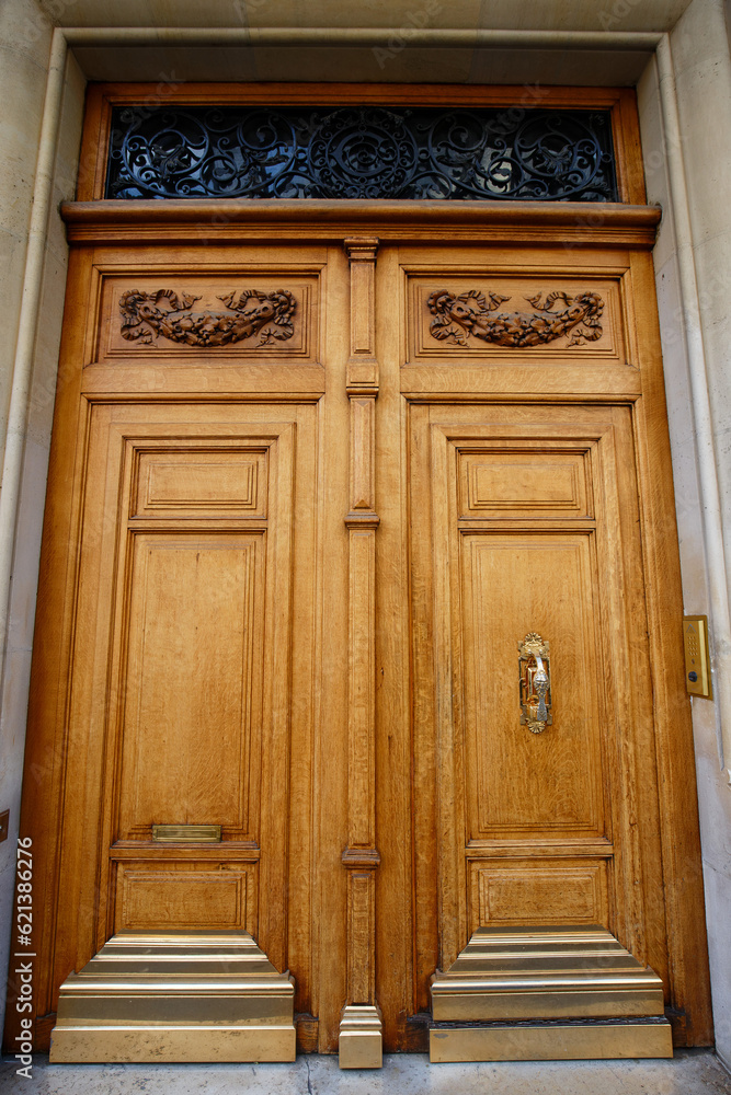 Old ornate door in Paris - typical old apartment buildiing. Old ornate door in Paris - typical old apartment buildiing.