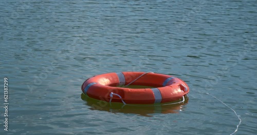 Safety on the water. A drowning person and a lifebuoy thrown into the lake. Drowning in vacation on a sunny day, sink.