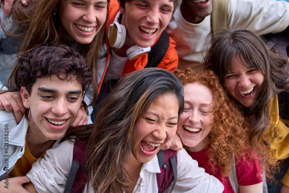 Close up of nice excited group of multi-ethnic college students hugging together. Happy smiling young classmates gathered on campus. Generation z people, language academies and back to class. Close up of nice excited group of multi-ethnic college students hugging together. Happy smiling young classmates gathered on campus. Generation z people, language academies and back to class.
