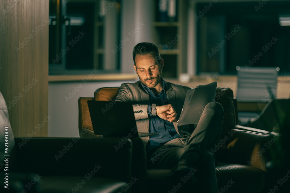 Businessman watching laptop with pensive and worried expression