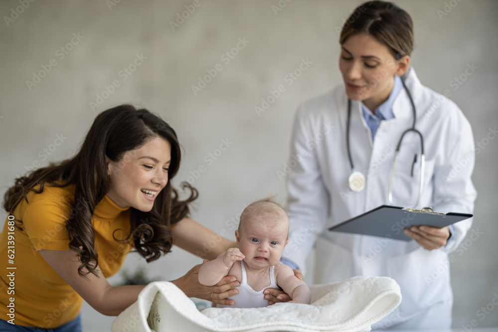Mother with her cute baby visiting pediatrician in clinic Mother with her cute baby visiting pediatrician in clinic