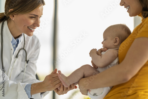 Mother with her cute baby visiting pediatrician in clinic
