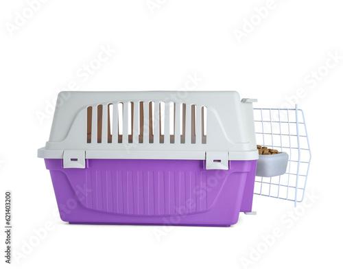 Violet pet carrier with bowl of dry food isolated on white