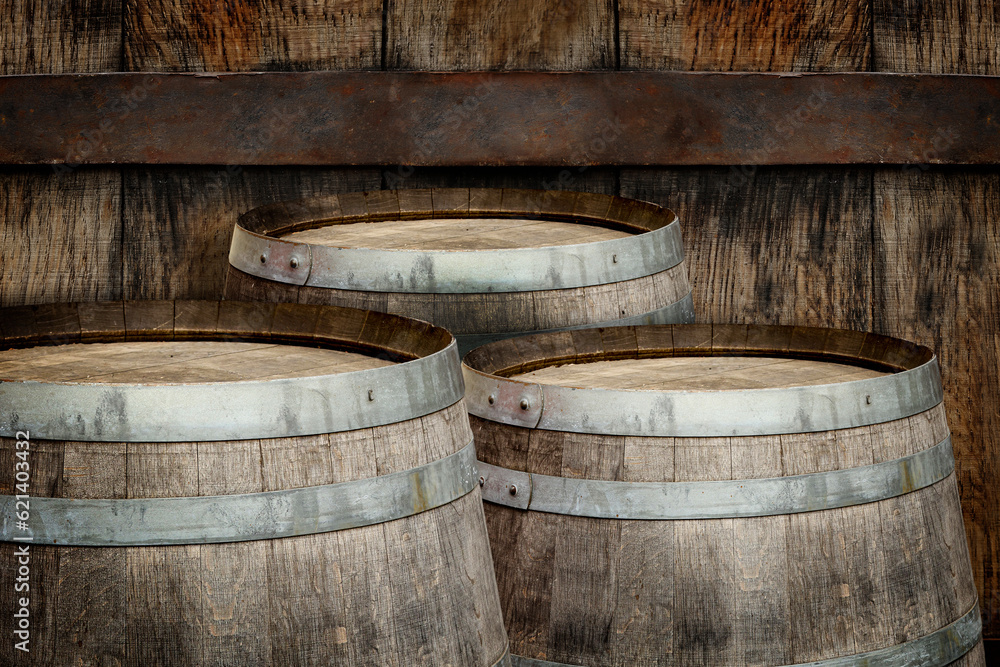 Three wooden barrels near old textured wall Three wooden barrels near old textured wall