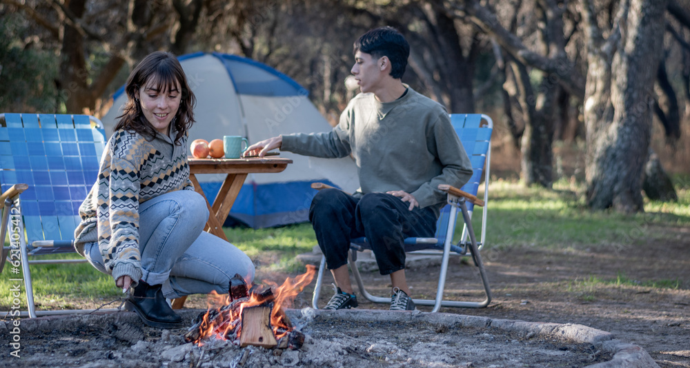 two fun friends having a campfire at the campsite two fun friends having a campfire at the campsite