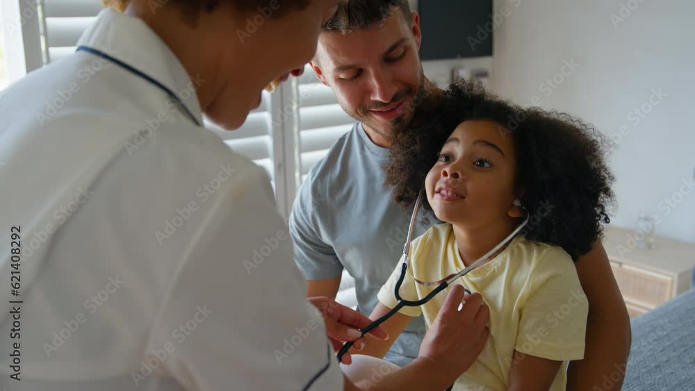 Female nurse wearing uniform gives girl patient stethoscope so she can