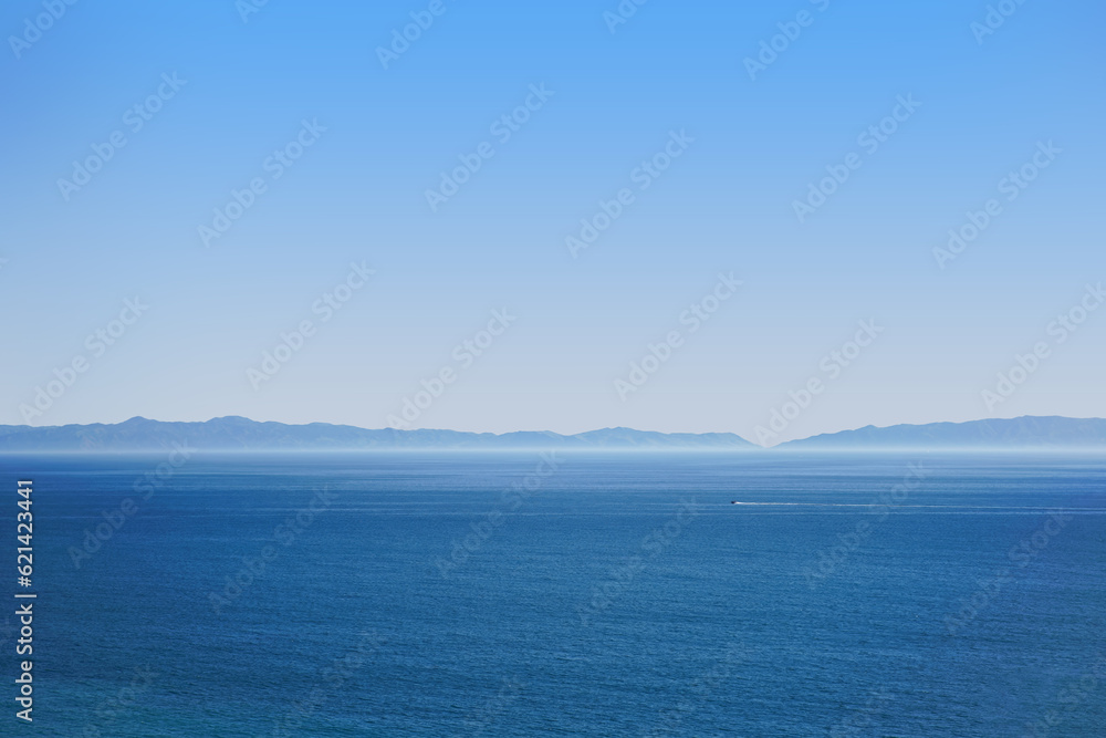 Hazy Ocean view with a boat in the distance