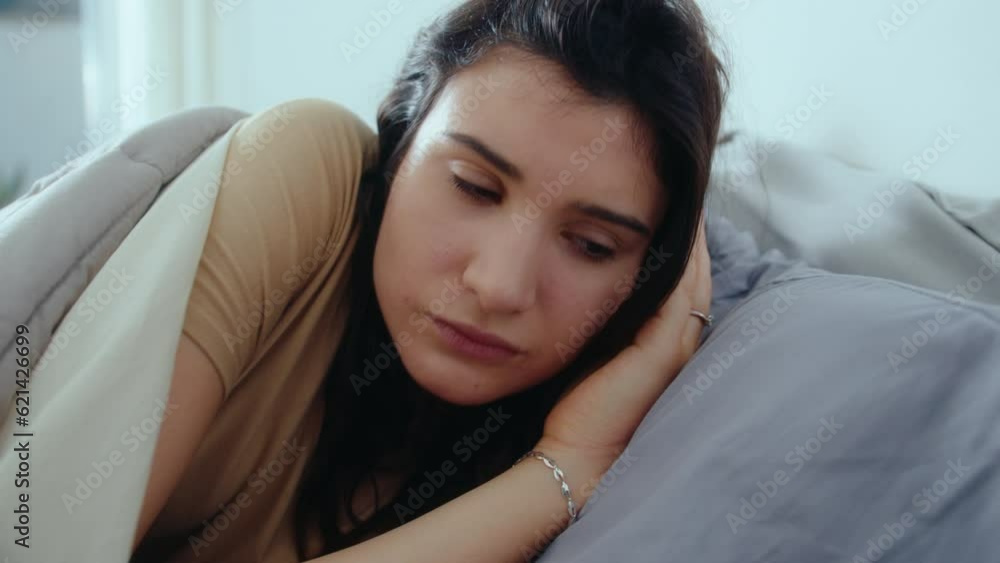 Young woman lying in bed, opening her eyes, taking smartphone and scrolling through the social media after waking up in the morning at home Young woman lying in bed, opening her eyes, taking smartphone and scrolling through the social media after waking up in the morning at home