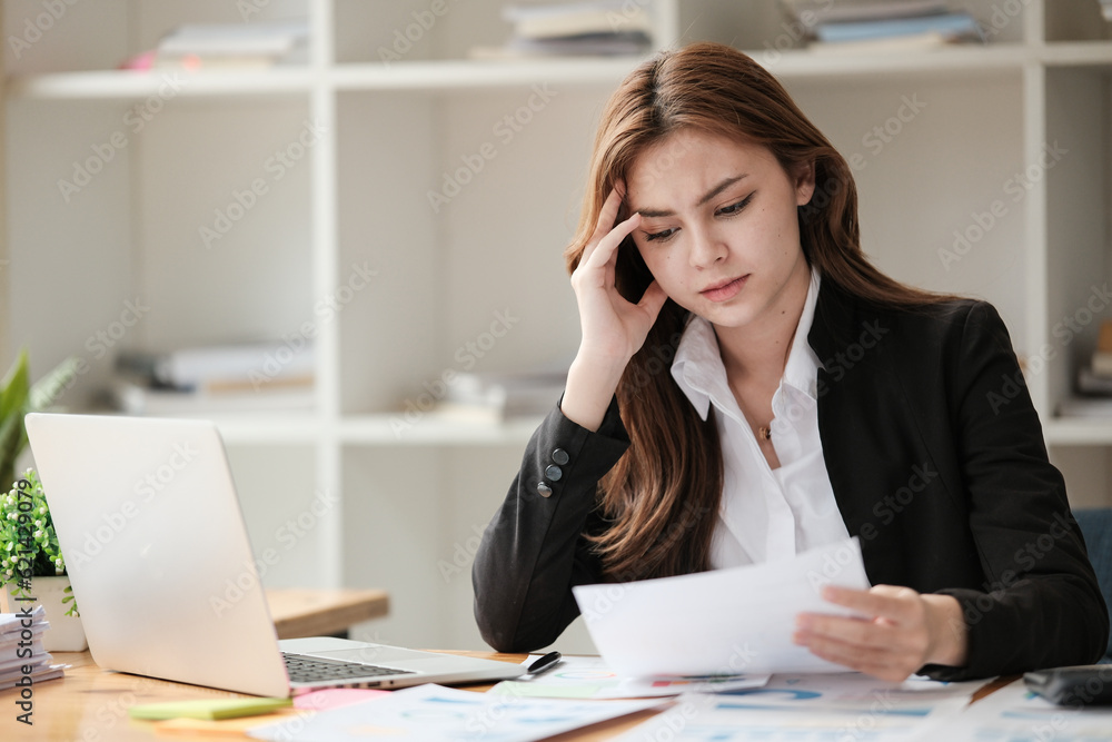 Business women are stressed while working on laptop, Tired asian businesswoman with headache at office, feeling sick at work, copy space Business women are stressed while working on laptop, Tired asian businesswoman with headache at office, feeling sick at work, copy space
