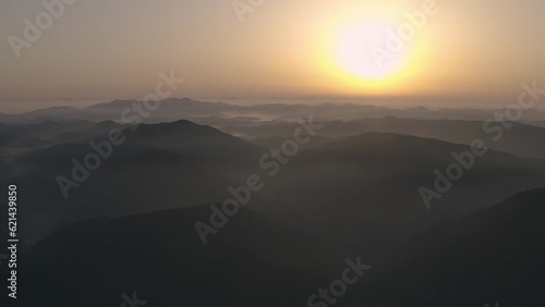 An aerial shot of the sky above a high-altitude mountain with a beautiful sunrise.