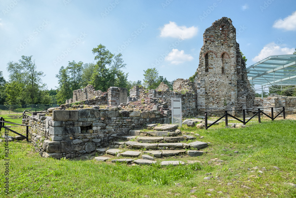 Ruins of a fortified settlement. Castelseprio, Italy and the remains of the Basilica San Giovanni at the monumental Longobard complex in the archaeology park of Castelseprio, UNESCO Site - obrazy, fototapety, plakaty 