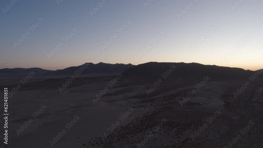 Aerial above Johnson Valley mountains and sand dunes at blue hour in California before sunrise Aerial above Johnson Valley mountains and sand dunes at blue hour in California before sunrise