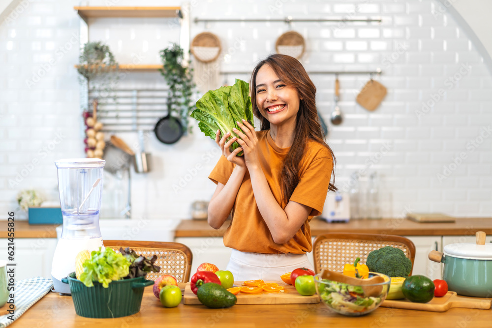 Portrait of beauty body slim healthy asian woman having fun cooking and preparing cooking vegan food healthy eat with fresh vegetable salad on counter in kitchen at home.Diet.Fitness, healthy food Portrait of beauty body slim healthy asian woman having fun cooking and preparing cooking vegan food healthy eat with fresh vegetable salad on counter in kitchen at home.Diet.Fitness, healthy food