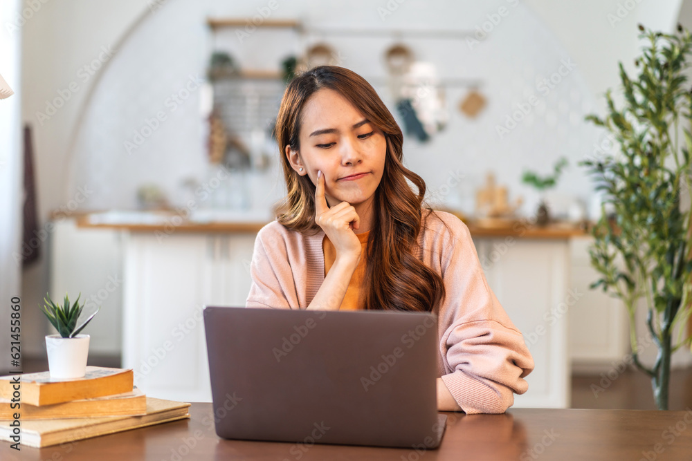 Portrait of asian woman use laptop work digital online marketing internet advertising and sales business technology concept, online marketing, E-business, Ecommerce, Business online at home Portrait of asian woman use laptop work digital online marketing internet advertising and sales business technology concept, online marketing, E-business, Ecommerce, Business online at home
