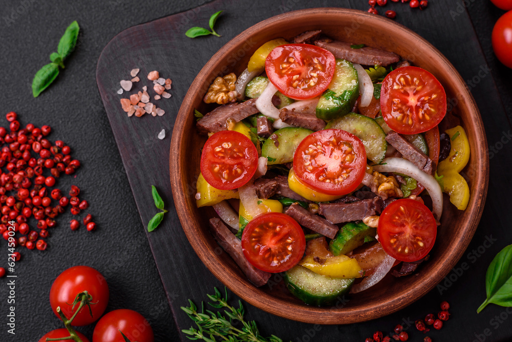 Delicious fresh salad with beef slices, cherry tomatoes, sweet peppers