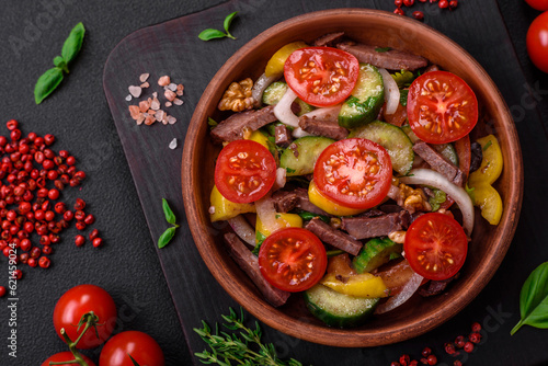 Delicious fresh salad with beef slices, cherry tomatoes, sweet peppers