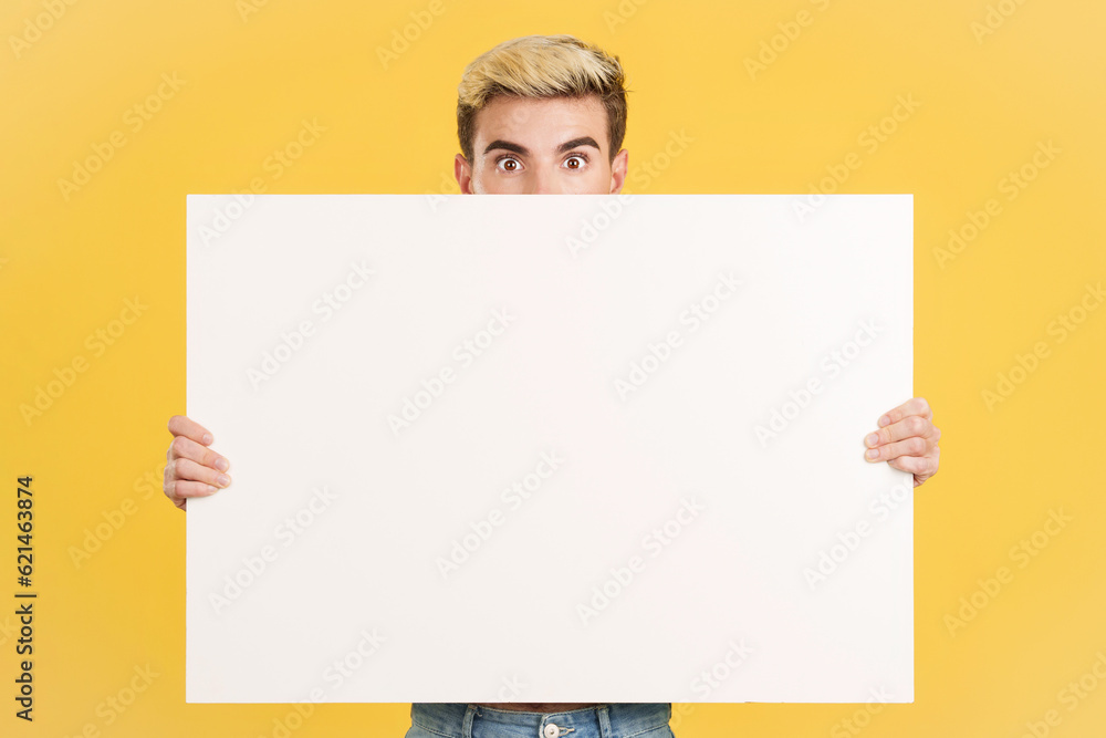 Surprised gay man hiding behind a blank board Surprised gay man hiding behind a blank board