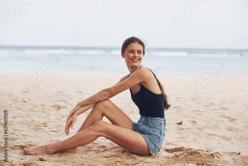 woman sand freedom sitting travel outdoor beach sea nature vacation smile