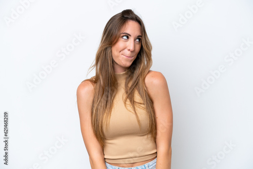 Young caucasian woman isolated on white background having doubts while looking up