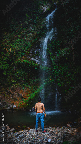 man in waterfall