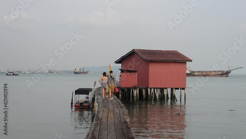  Chew Jetty UNESCO Chinese settlement listed with Chew clan wooden paths, colorful street art and buildings. It is known for its traditional food and shops. photo
