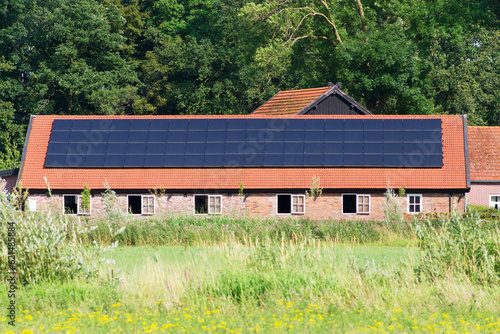Shed of a farm with red roof with solar panels in Arnhem in the Netherlands