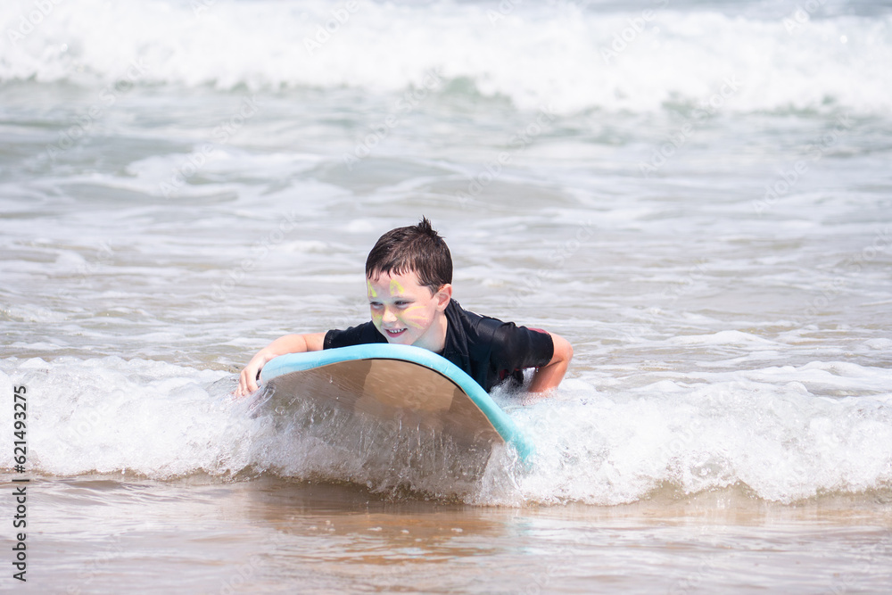 Young surfer rides surfboard in the ocean waves Young surfer rides surfboard in the ocean waves