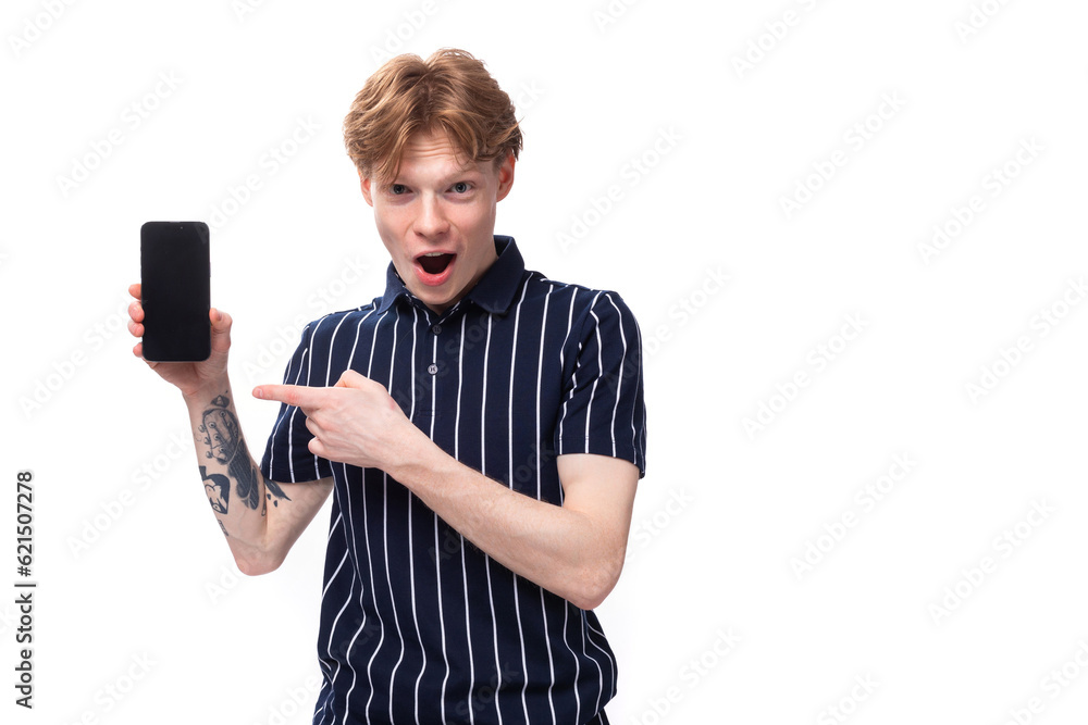 short-haired 25 year old blond male with tattoos in a striped polo showing ads on the phone short-haired 25 year old blond male with tattoos in a striped polo showing ads on the phone