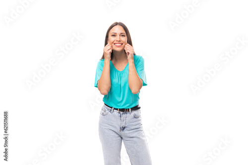 30 year old attractive brunette woman with flowing straight hair put on a blue T-shirt and jeans