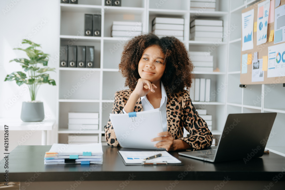 Successful African Businesswoman Analyzing Finance on Tablet and Laptop at modern Office Desk tax, report, accounting, statistics, and analytical research concept.. Successful African Businesswoman Analyzing Finance on Tablet and Laptop at modern Office Desk tax, report, accounting, statistics, and analytical research concept..