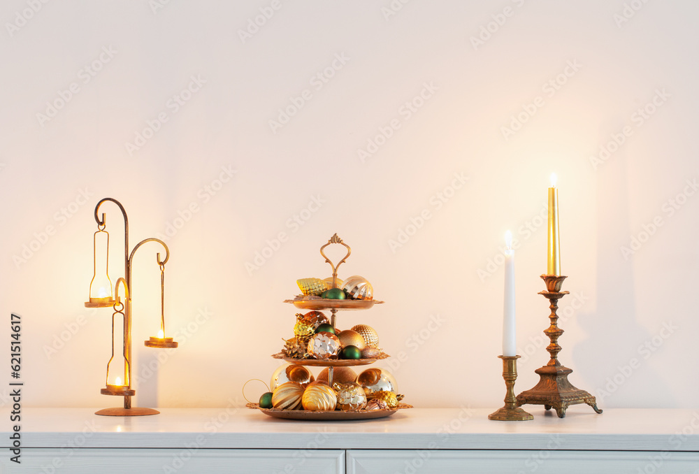 christmas golden decor with burning candles in white interior christmas golden decor with burning candles in white interior