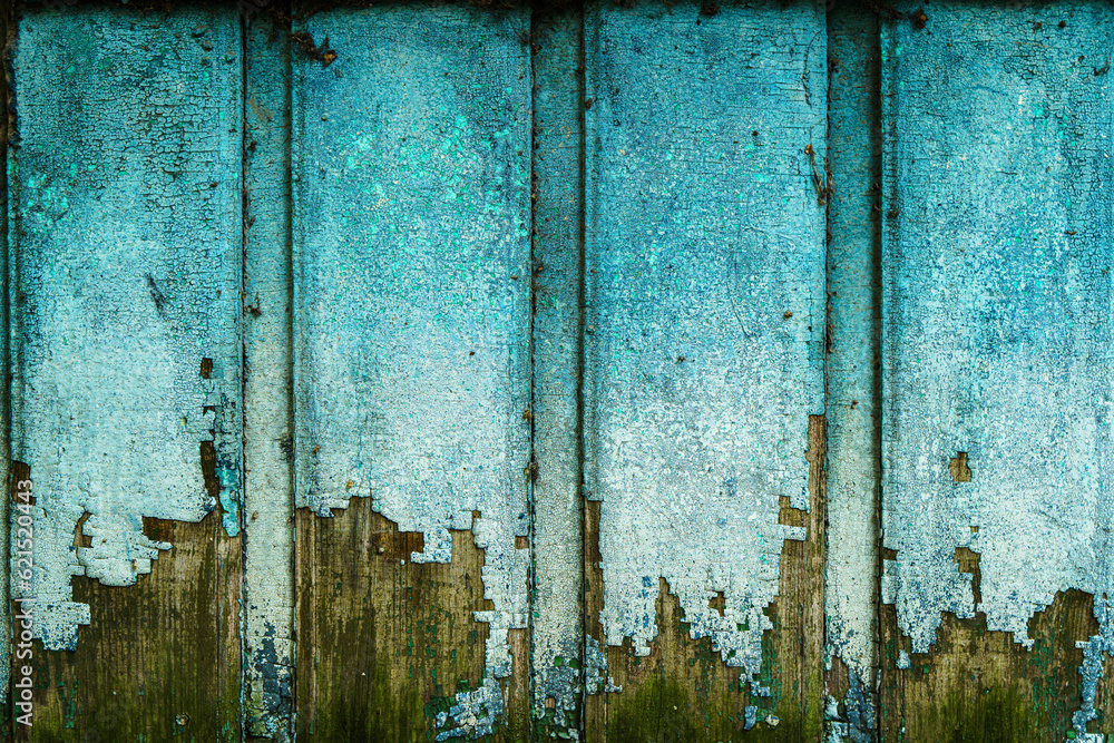 Old gloomy wall with peeling cyan paint