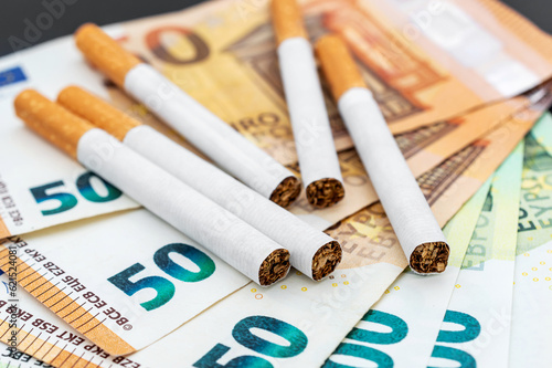 Cigarettes on the euro bills. Close up.