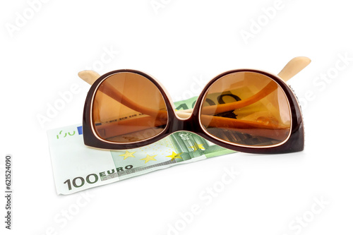 Sunglasses with one hundred euro bill on a white. photo