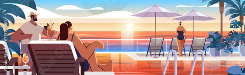 people relaxing at tropical luxury resort hotel beach swimming pool and poolside seating area summer vacation concept