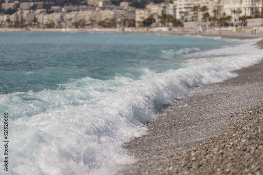 Fototapeta premium Morning waves on pebble beach in Nice, France