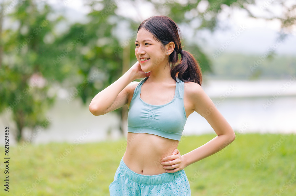 An asian female smiling while exercising. An asian female smiling while exercising.