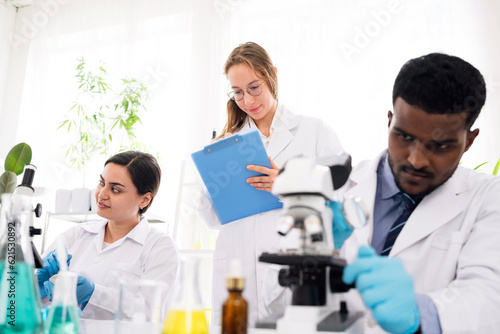 The diversity of scientists reports experimentation results to their colleagues in the research laboratory. Group of chemistry students working in the laboratory.