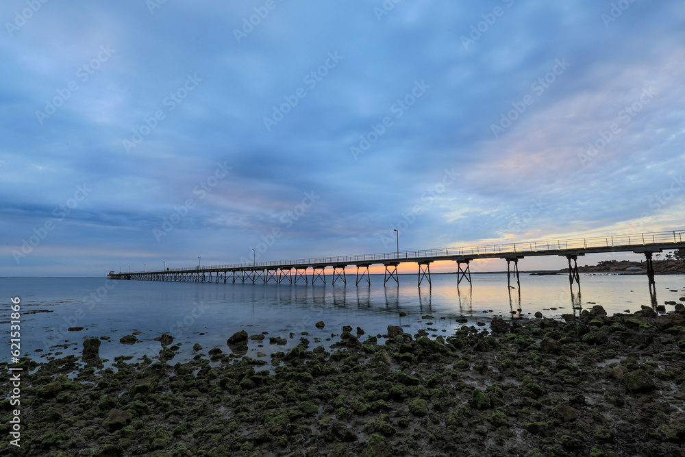 Scenic view of Ceduna jetty beneath cloudy sky at sunset