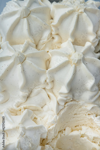Vanilla ice cream stored in a display case  a classic and versatile frozen desert with a smooth and creamy texture and a flavor profile characterized by a delicate  sweet  and slightly floral taste